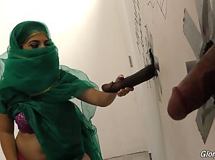 Muslim bitch sucking cocks at a gloryhole and receives a facial